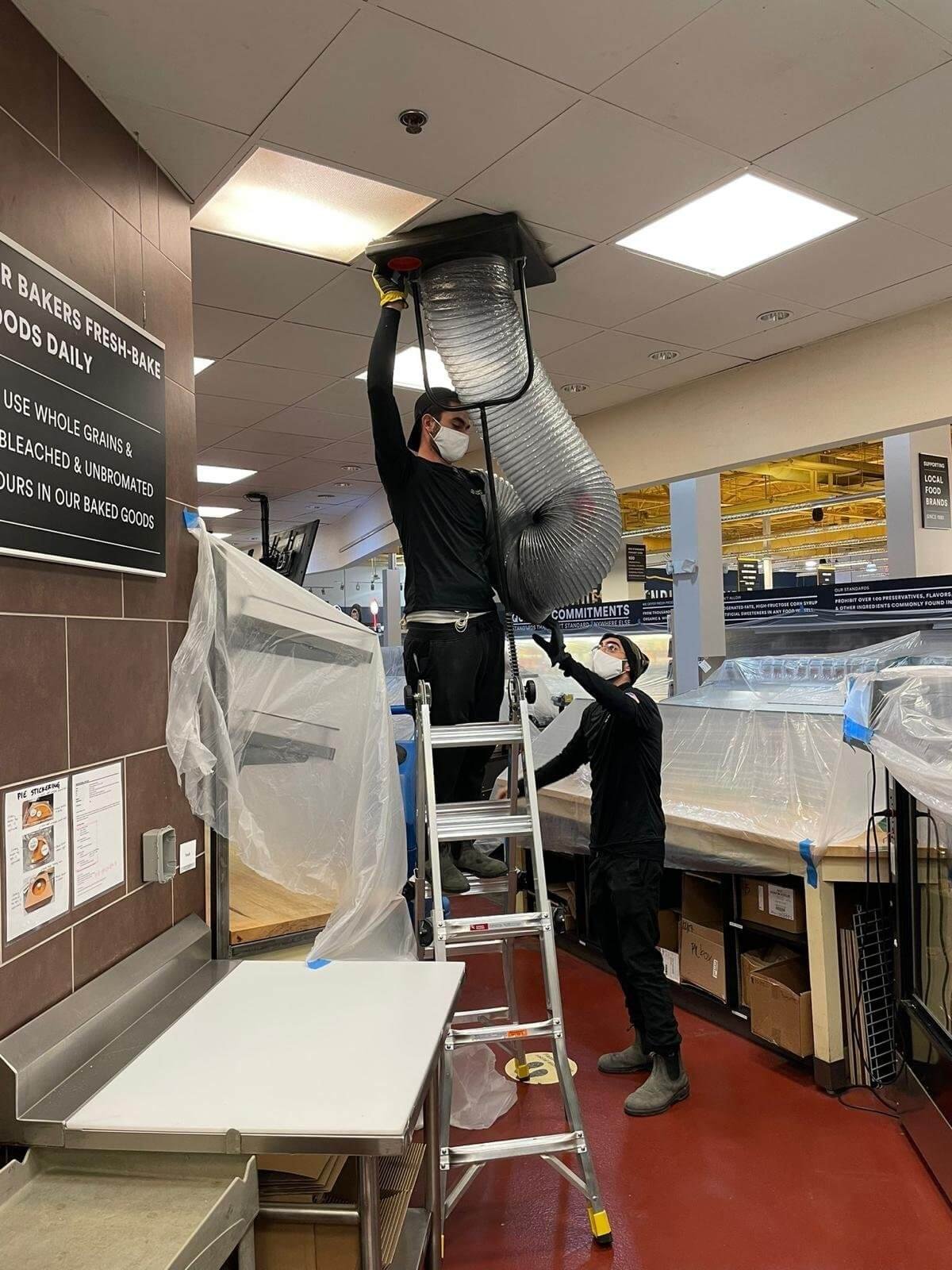 united home services tech cleaning air ducts 1 1 1